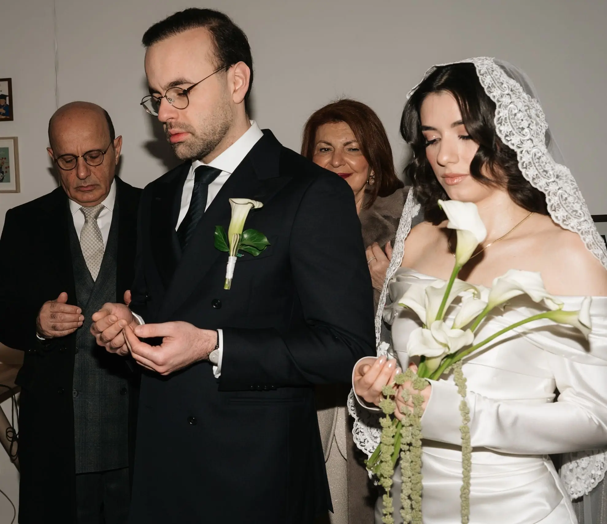 Bride and groom with family during the traditional picking up of the bride
