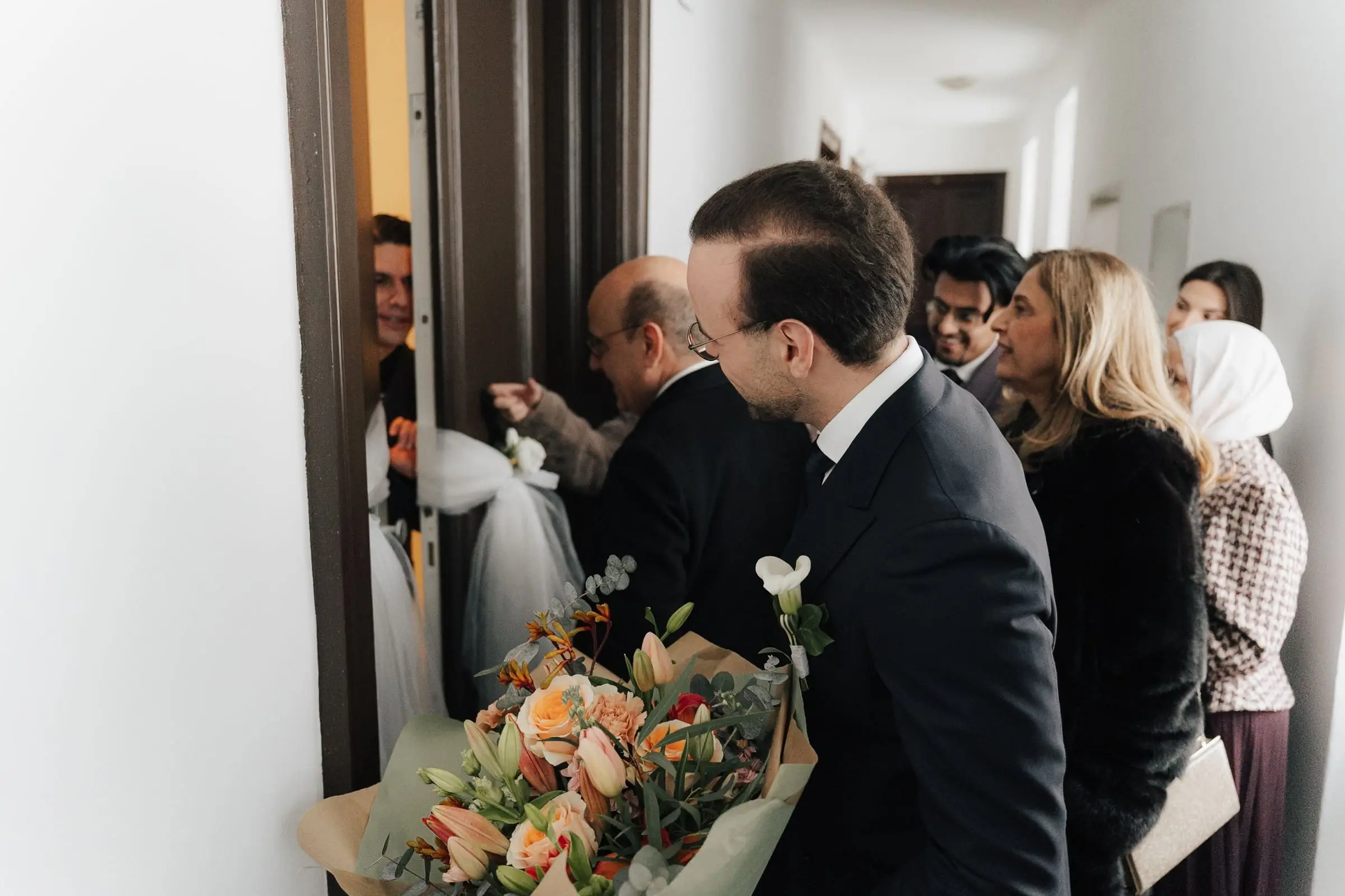 Groom arriving with flowers to pick up the bride at her home
