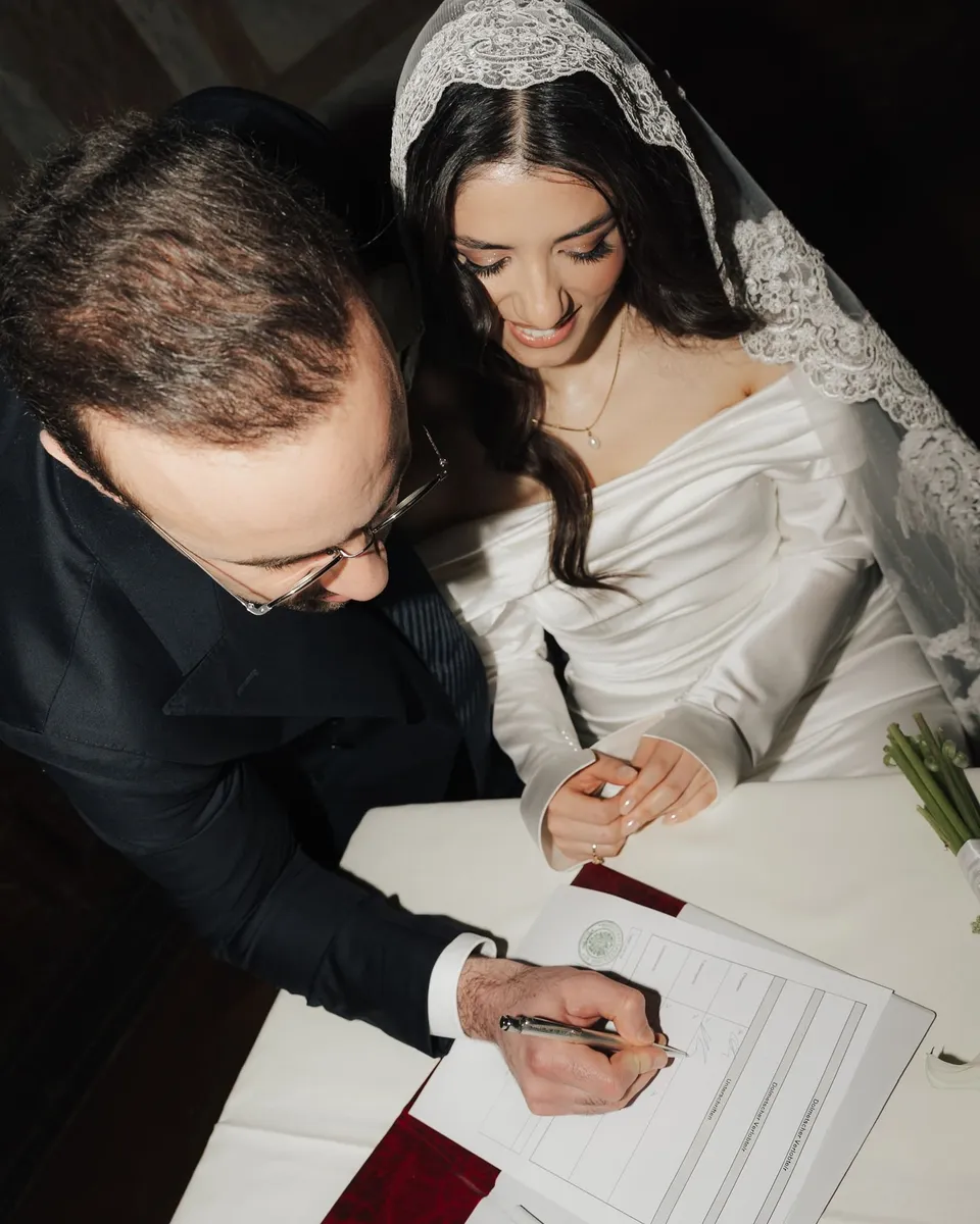 Groom and bride signing the marriage certificate