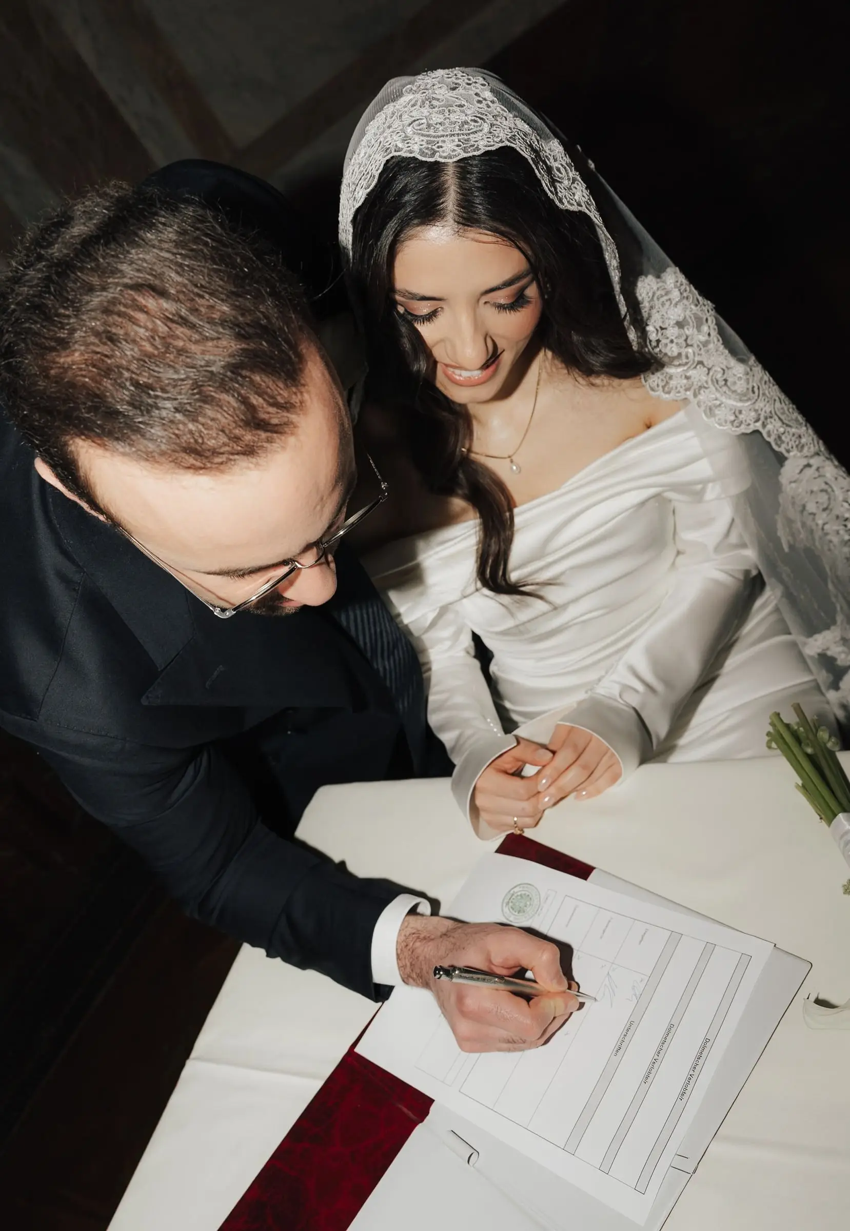 Groom and bride signing the marriage certificate