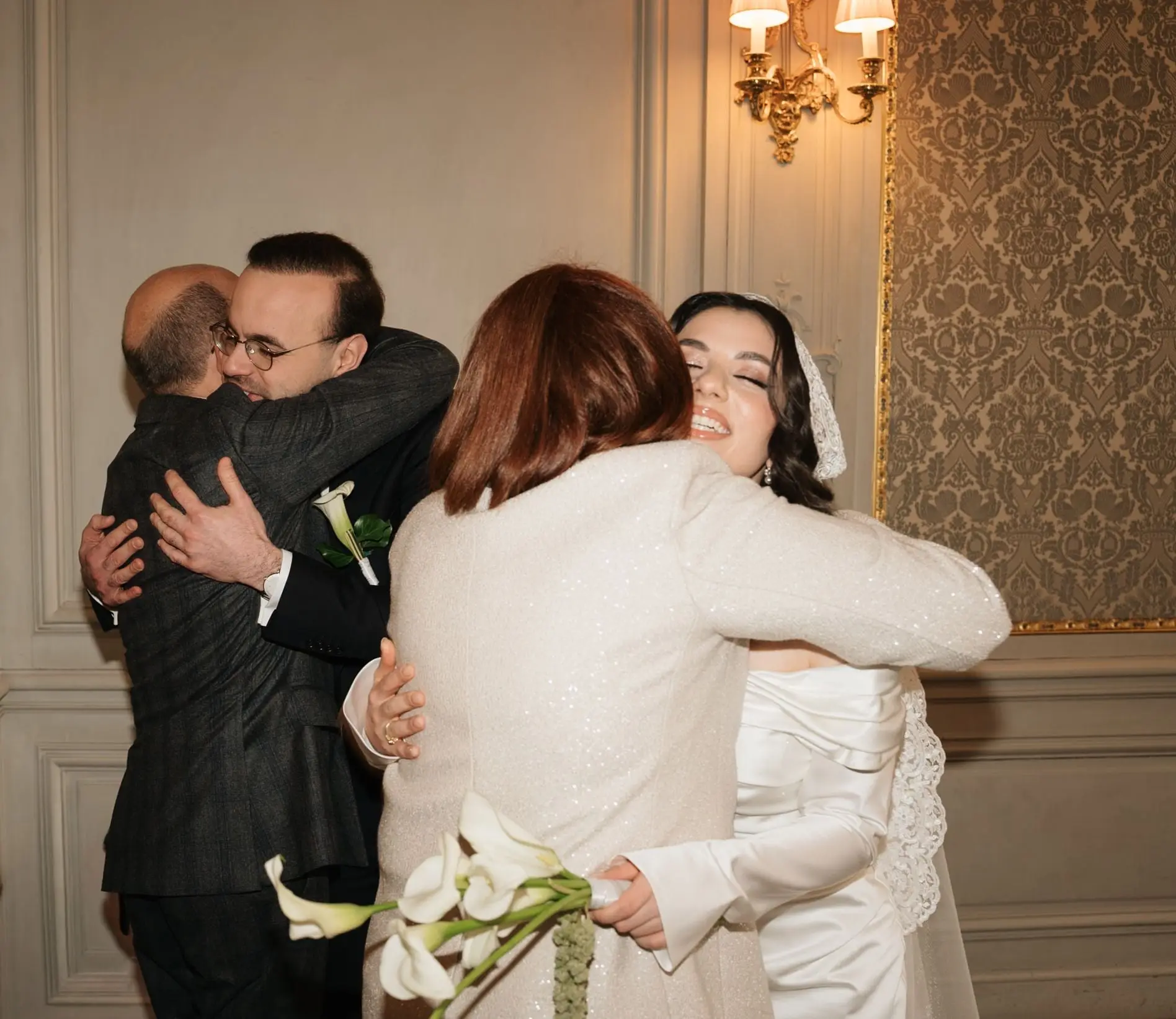 Couple hugging their parents after the ceremony