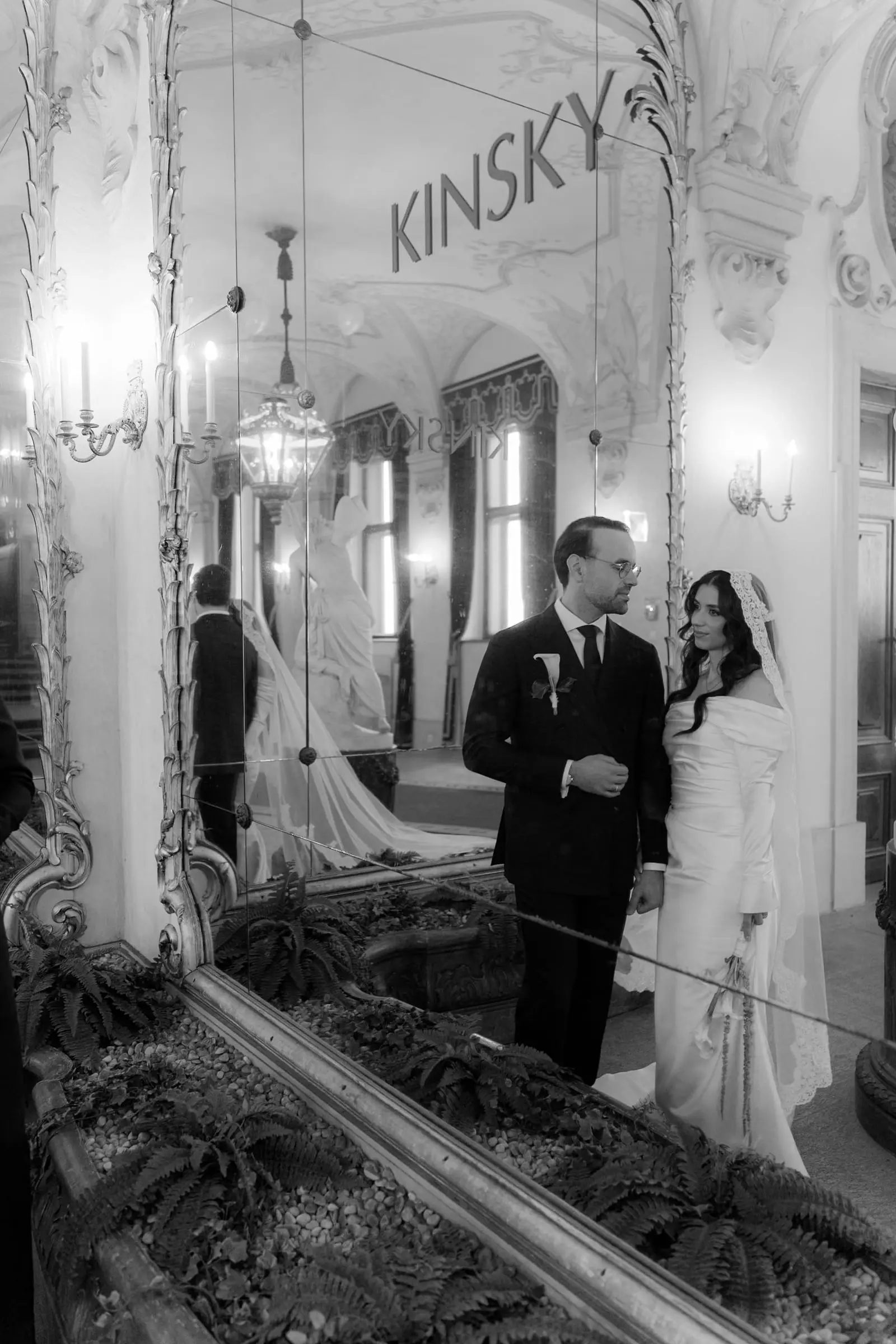 Black and white photo of the couple reflected in a mirror reading Kinsky