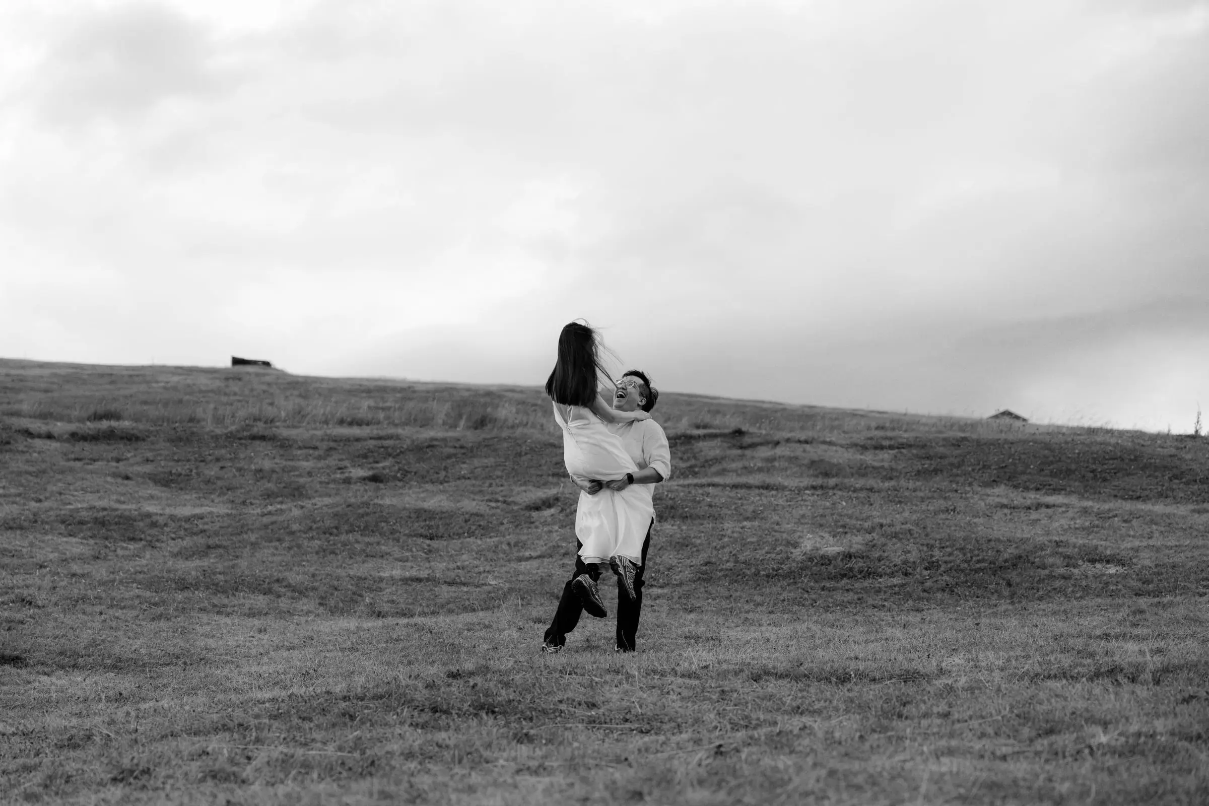 Black and white photo of him lifting her after she said yes