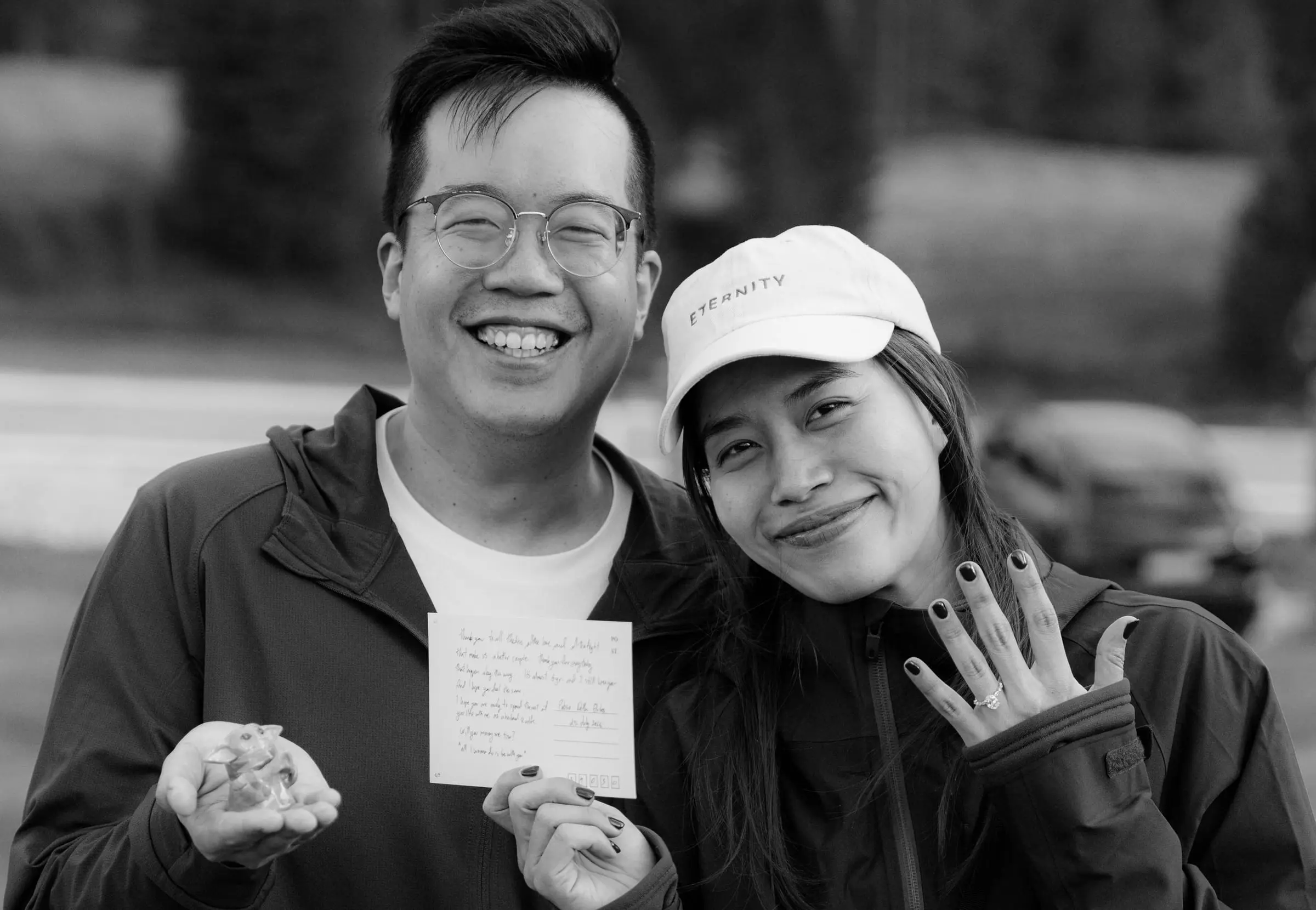 Black and white photo of the couple showing the ring and a handwritten letter
