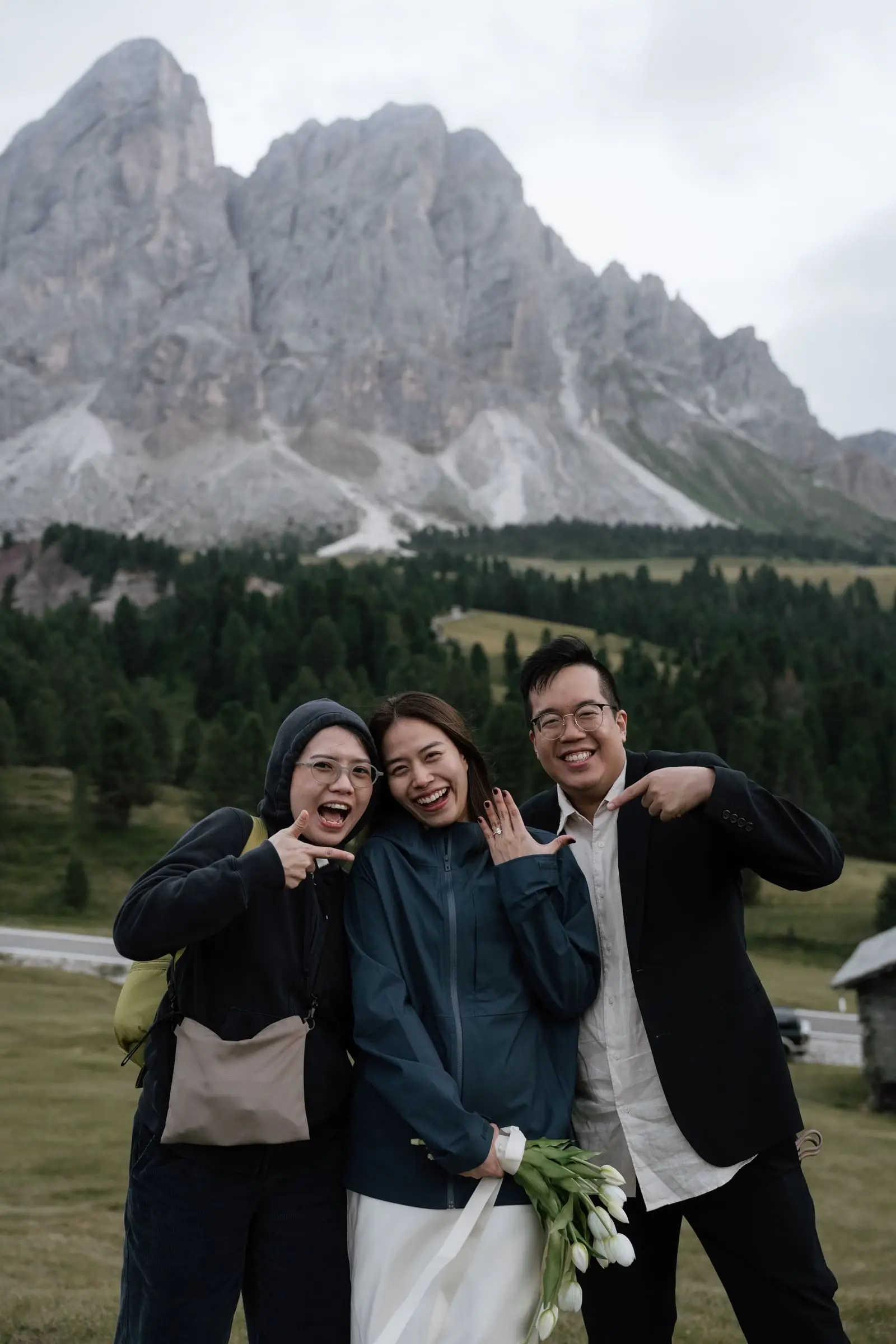 The couple and their friend celebrating in front of the Sass de Putia