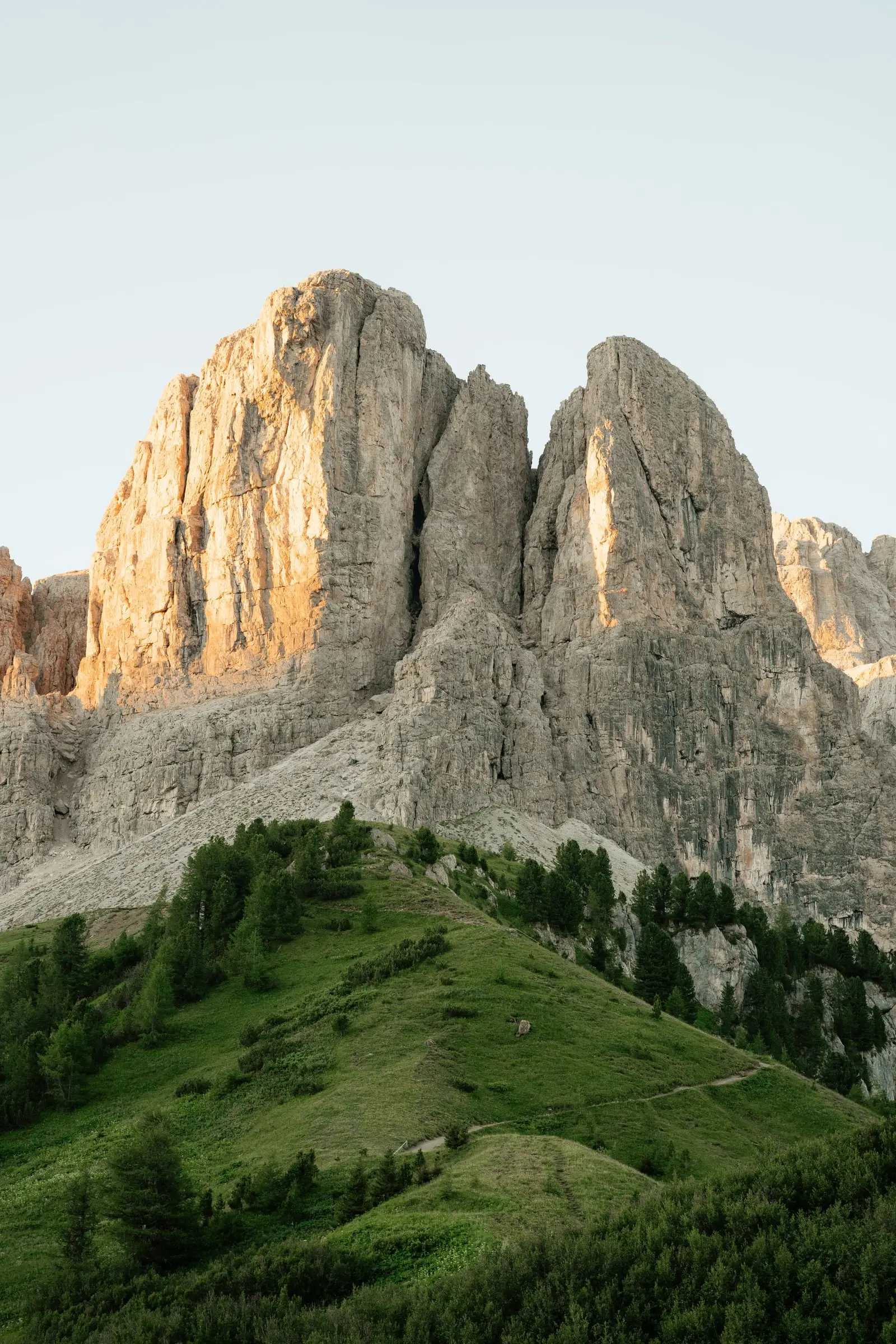The Sella rock towers glowing in golden light above Passo Gardena