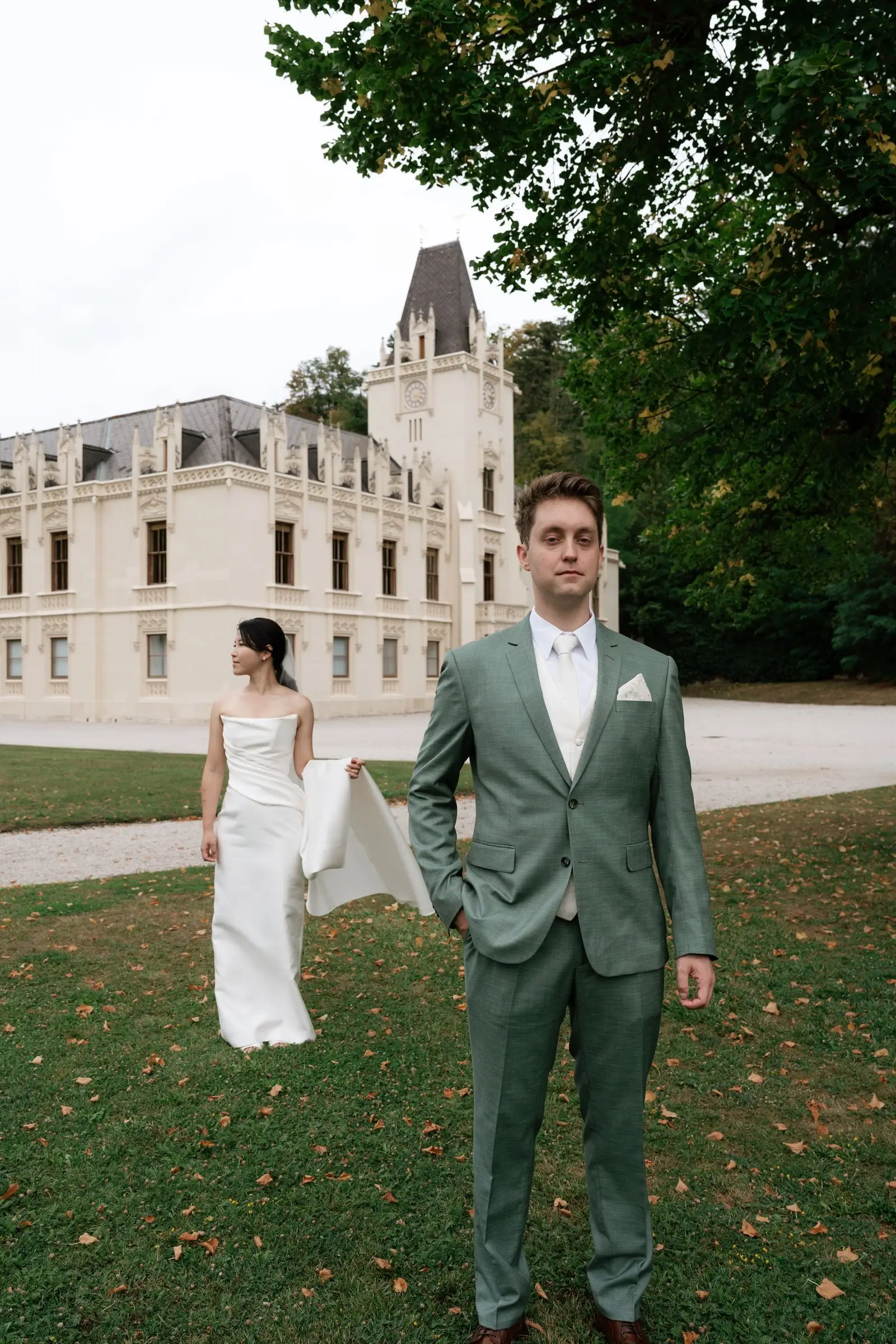 Bride walks towards the groom for the first look in front of Schloss Hernstein