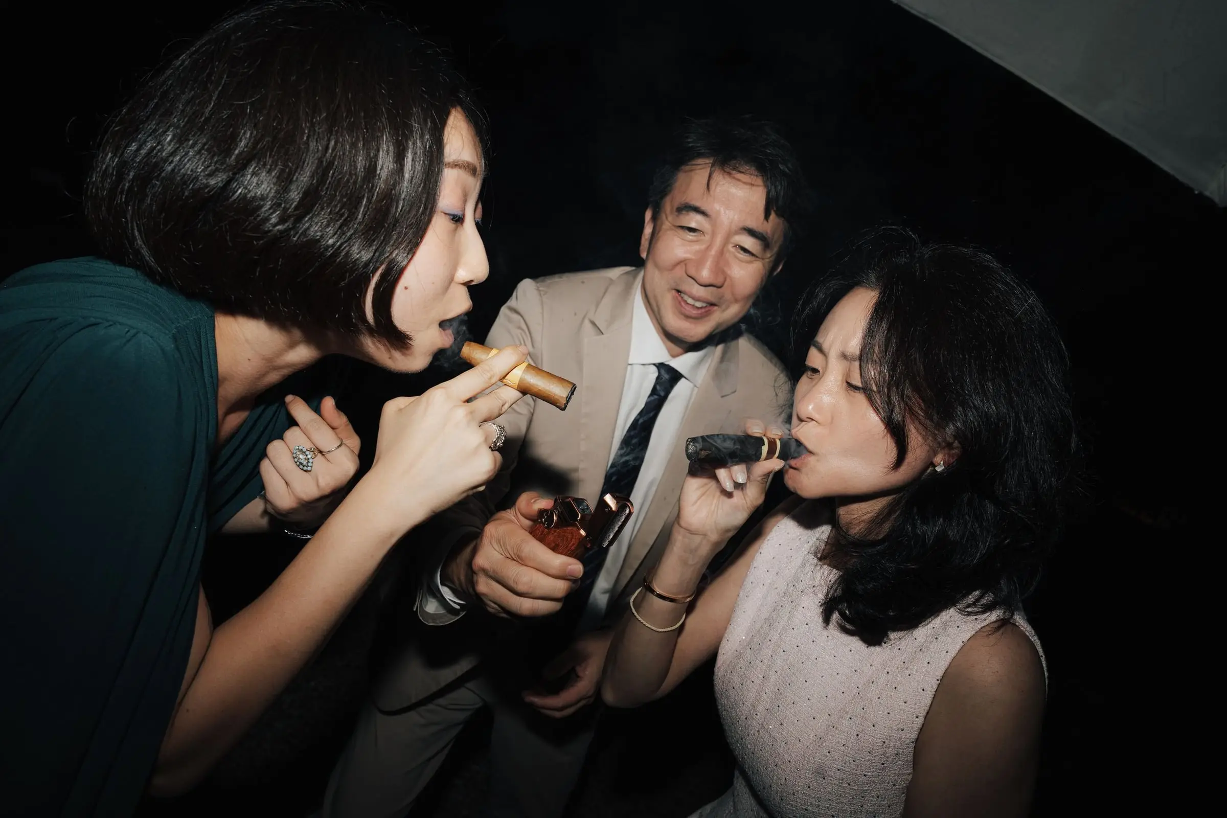 Guests celebrating with cigars late at night