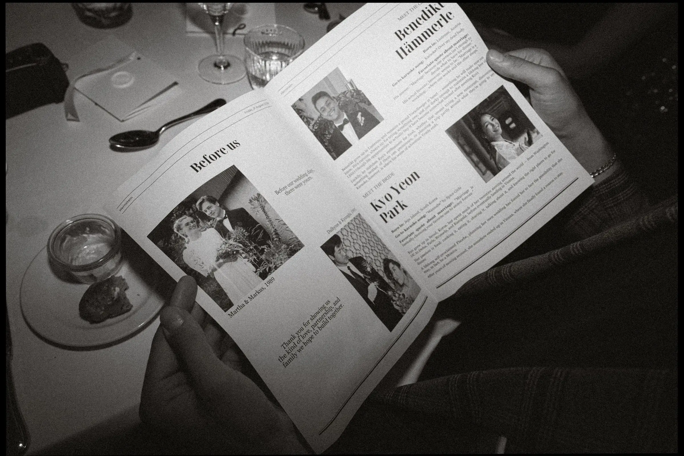 Black and white photo of a guest reading the wedding newspaper