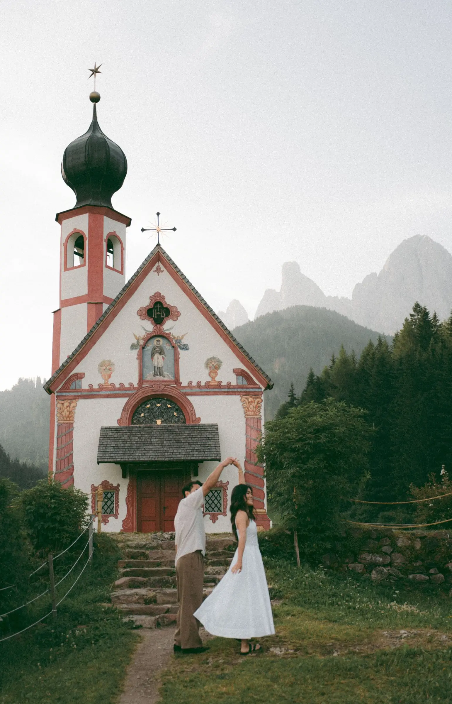 Couple dancing in front of St. John's Chapel in Ranui