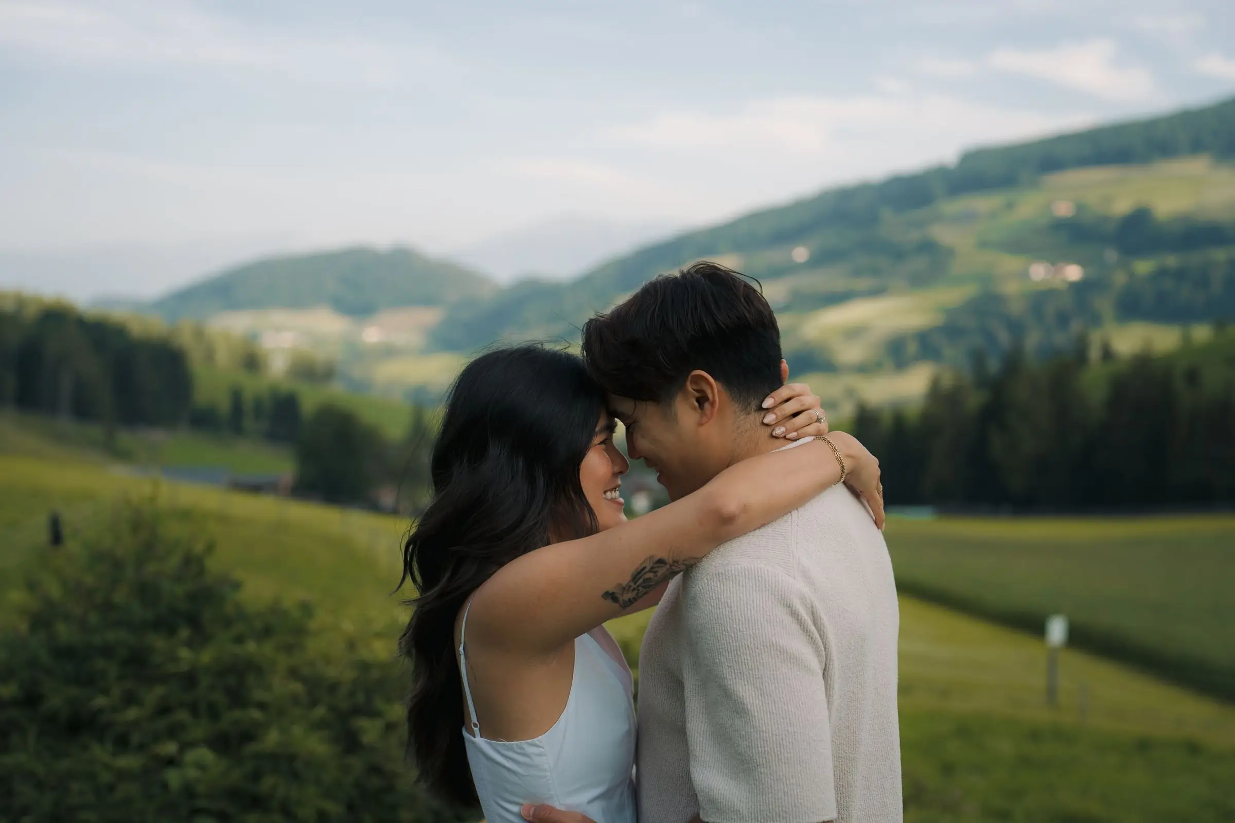 Couple forehead to forehead in the meadows of Val di Funes