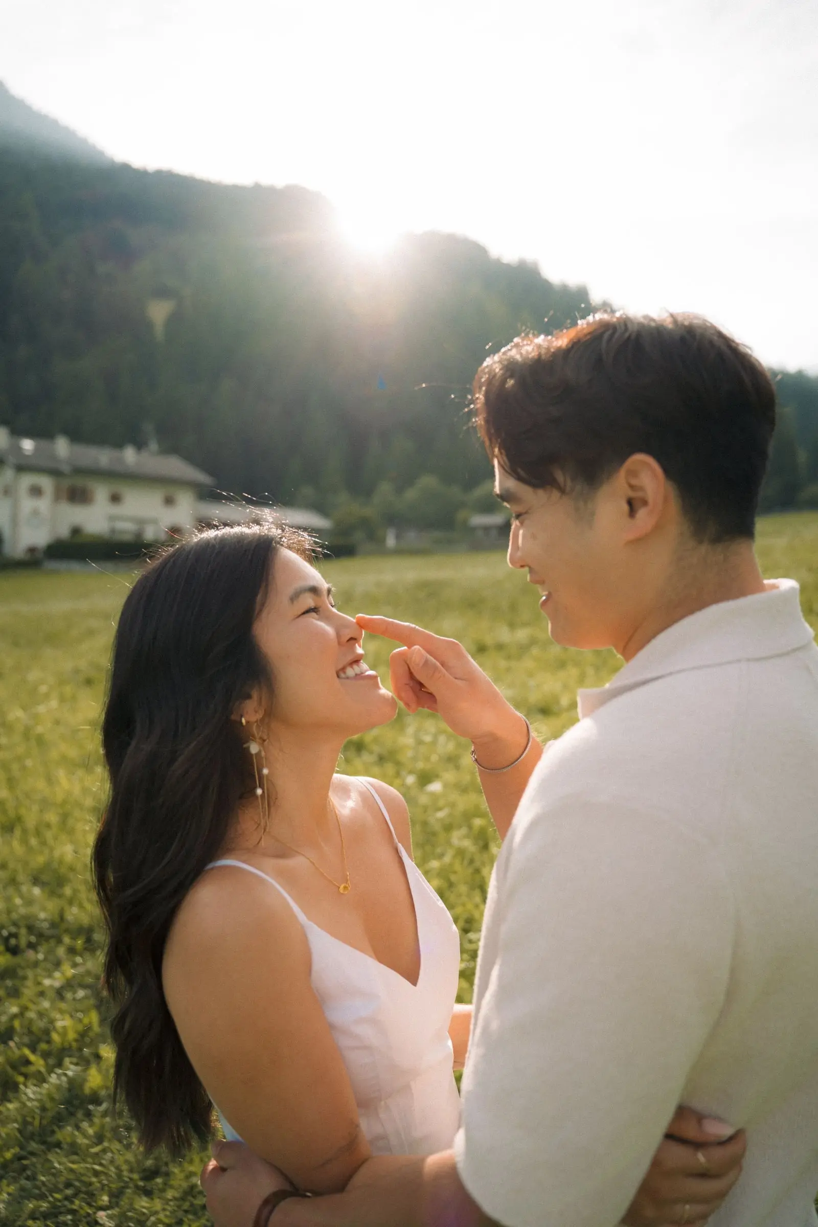 He gently touches her nose as the sun sets over the hills