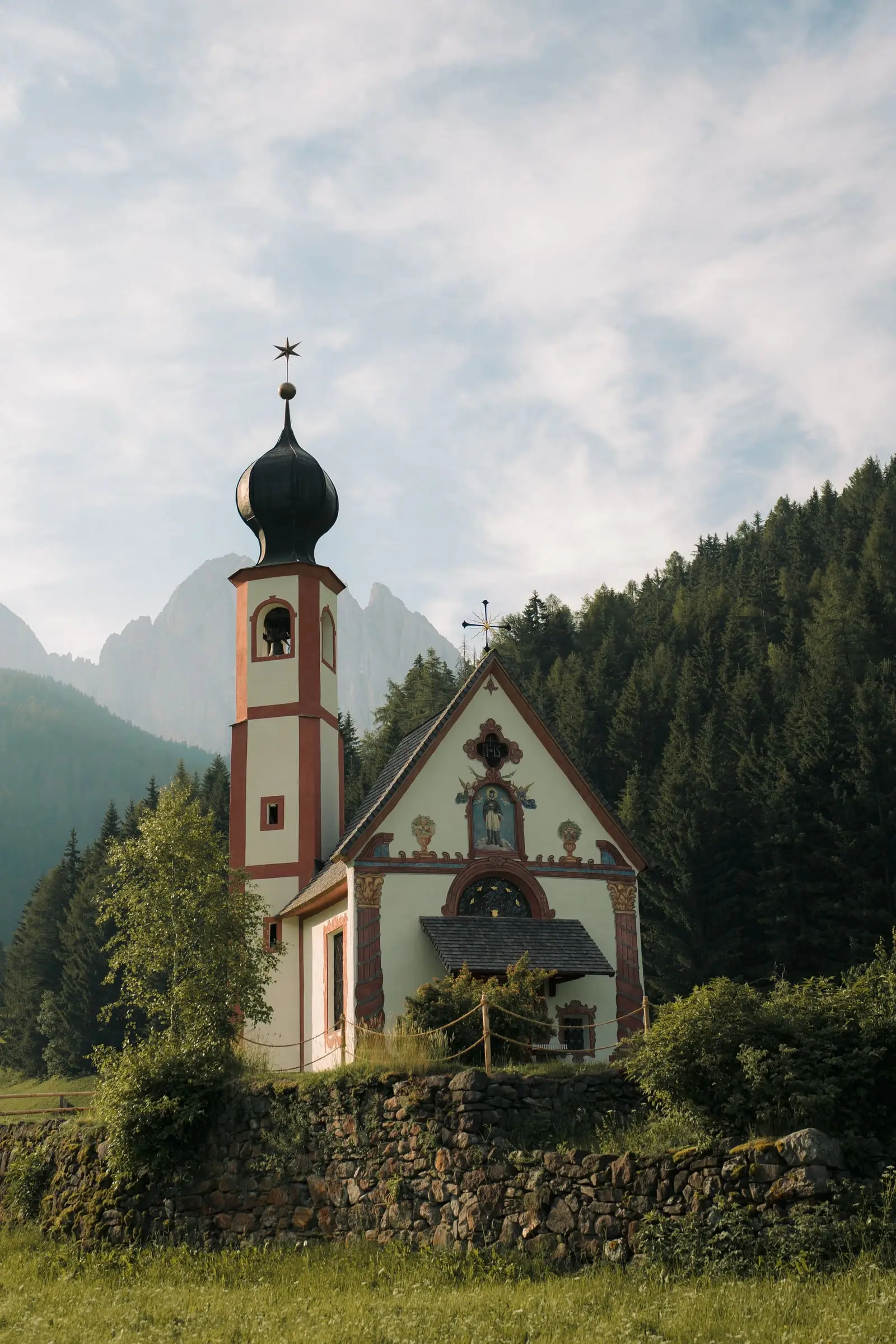 St. John's Chapel in Ranui with its onion dome below the Odle peaks